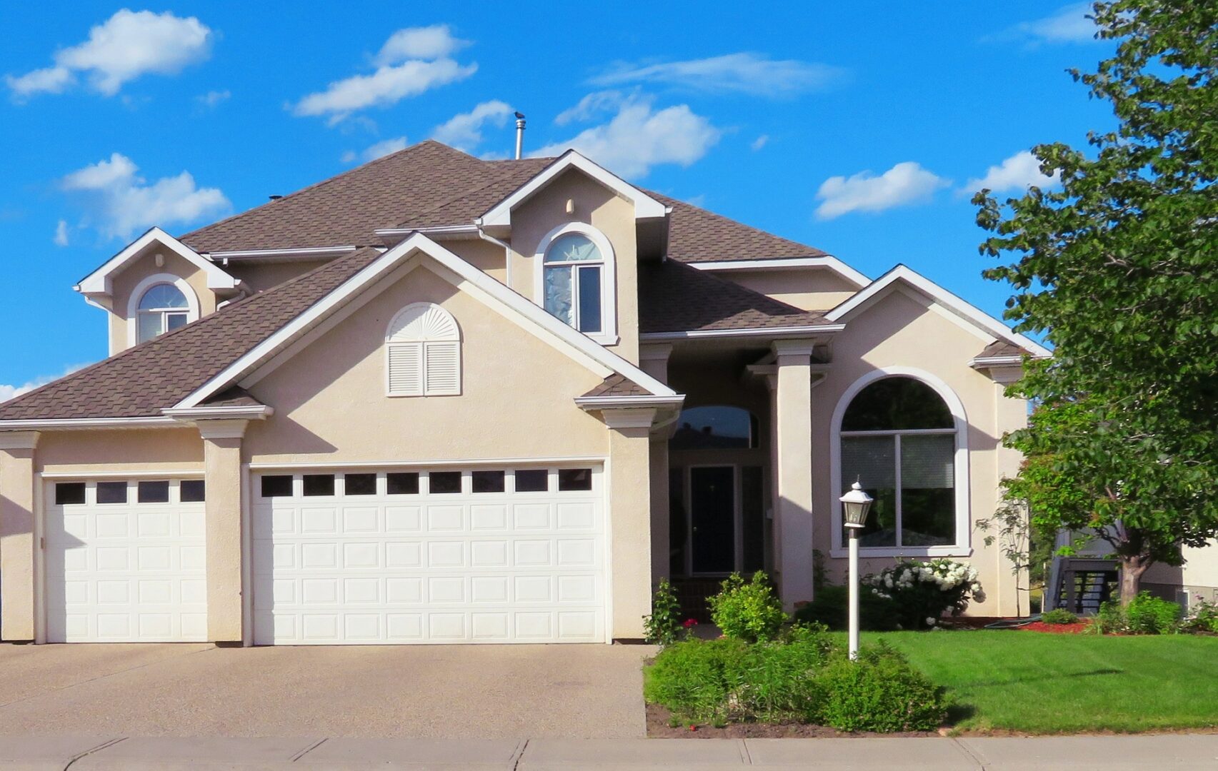 A house with a driveway and garage door.