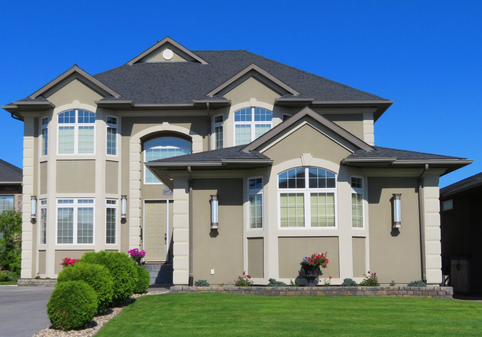 A large house with a lawn in front of it.