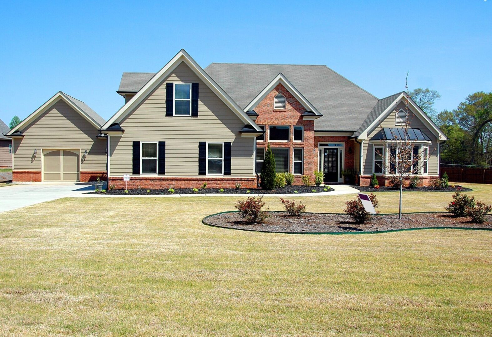 A large house with a lawn in front of it.